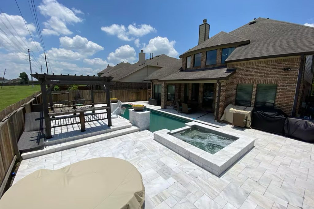 Backyard pool deck with pergola in Pearland