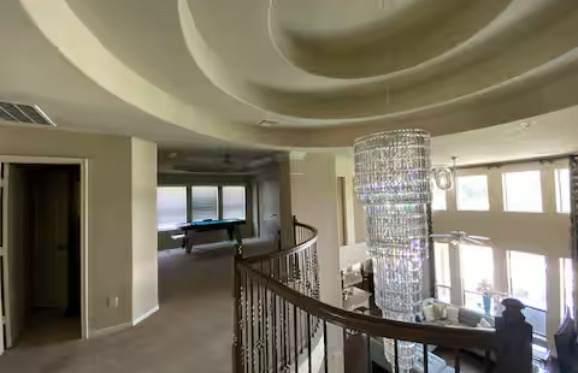 Upstairs landing with chandelier in Pearland